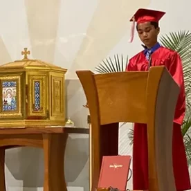 Graduate reading at mass