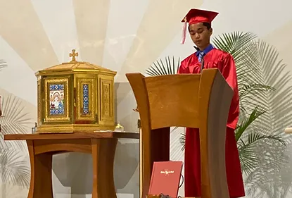 Graduate reading at mass